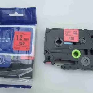 Close-up view of the TZ2-431 cartridge output guide channel highlighting the pre-aligned 12mm red laminated media strip and protective overlay.