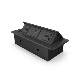 Sleek Nexa multifunction flip-up socket in a matte black finish installed flush on a modern office conference table.