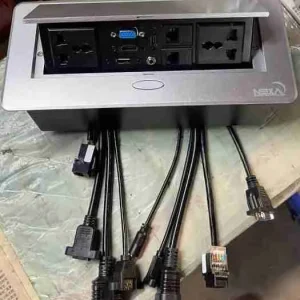 Low-profile Nexa silver flip-up multi-outlet tabletop socket designed for seamless cable management in executive boardrooms.