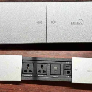 Sleek Nexa multifunction slide cover socket in a brushed silver finish installed flush on a modern office desk with its cover smoothly retracted.